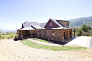 Custom home by Peterson Builders featuring stone exterior and mountain backdrop, showcased in Parade of Homes 2012.