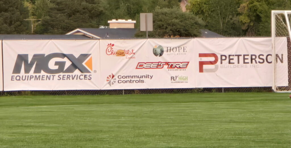 Peterson builders banner at Morgan Highschool sponsoring Girls Soccer Team