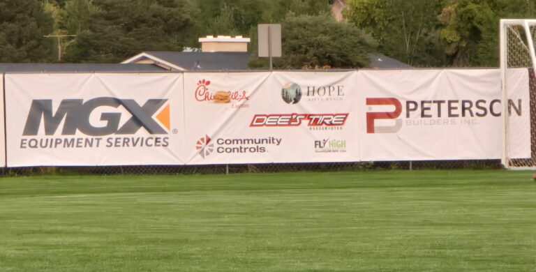 Peterson builders banner at Morgan Highschool sponsoring Girls Soccer Team